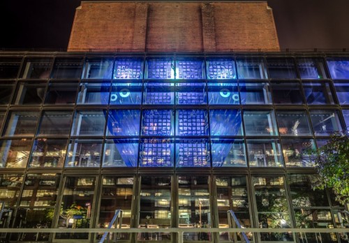 Watermark art installation as part of the west-facing façade of the theatre, backlit with LED lights at night © Sarah Hall